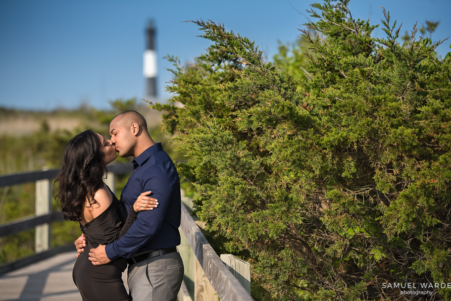 engaged couple sharing a kiss in the sun atFire Island