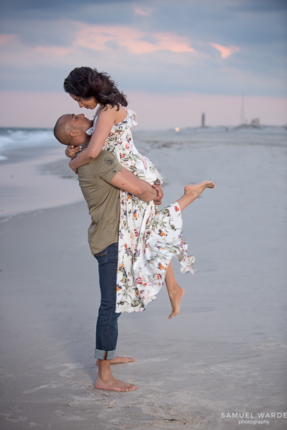beautiful engaged couple at beach sharing a romantic moment